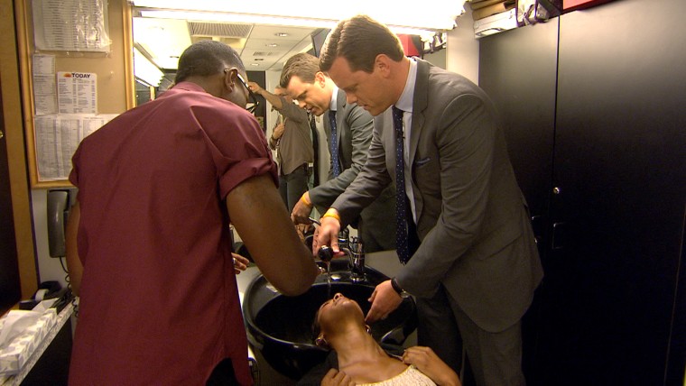 Willie Geist helps wash Tamron Hall's hair in preparation for a segment on natural hair.