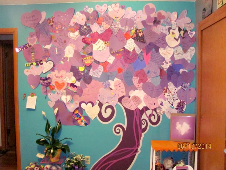 A local artist drew a tree trunk — the canopy of “leaves” of the design in the wounded girl’s room consists of purple hearts sent from people from aro...