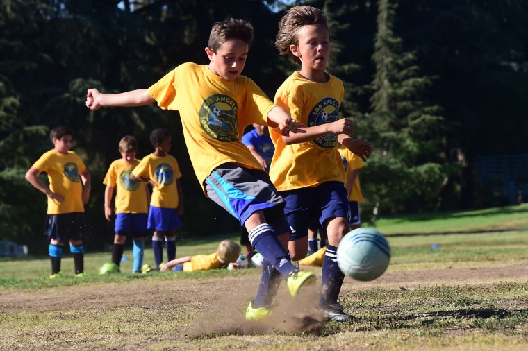 Youth soccer players from coach Jose Aguilar's team of under-10-years-olds work on their shooting during a training session for players in the Los Angeles Soccer Association on June 4, 2014, in Los Angeles.