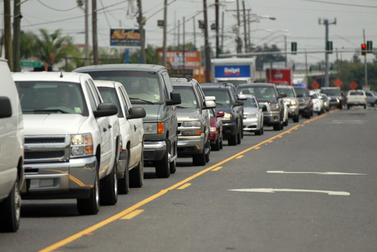 A line of traffic extends down Airline Highway as residents leave the New Orleans area in anticipation of Tropical Storm Isaac, in Kenner, La., Monday...