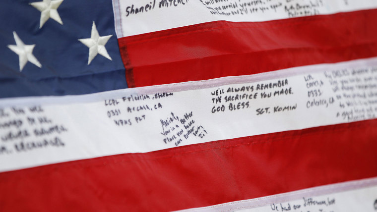 A detail of Lance Cpl. Fred Maciel's flag made in his honor was found by Lanie and Walter Brown at a flea market and presented to his mother, Saturday...