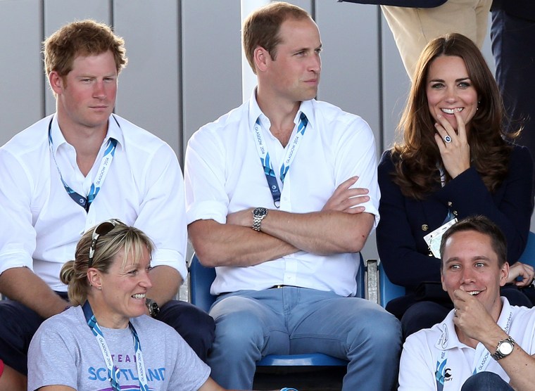 Britain's Kate Duchess of Cambridge, right, and Prince William, center, and Prince Harry, left, react as they watch the women's field hockey match bet...