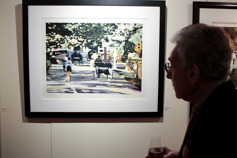 Image: A visitor admires the painting \"Sunday in Central Park\" by Tony Bennett in a New York City art gallery.