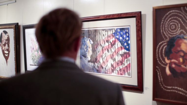 Image: A gallery visitor admires a painting by Tony Bennett
