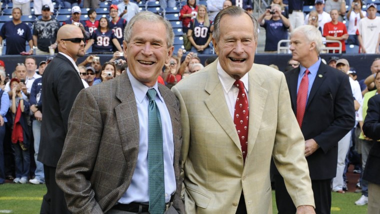 FILE - This Oct. 25, 2009 file photo shows former Presidents George H. W. Bush, right, and George W. Bush before the Houston Texans NFL football game ...
