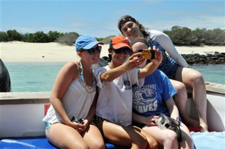 Image: This July 2014 photo provided by Adios Adventure Travel shows a group of American high school students, from left, Isabela Gettier, Elizabeth Thomas, Hannah Whitt Linsly and Stephanie Kirby posing for a group selfie on a trip to the Galapagos.