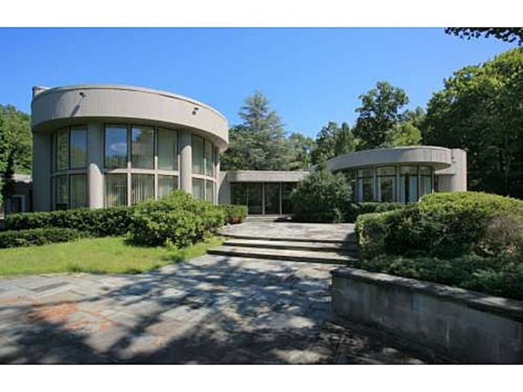 Whitney Houston's former home includes walls of windows, a swimming pool and two Jacuzzis.