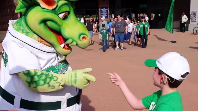 The Dayton Dragons mascot signs with a deaf boy.