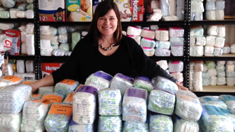 Michelle Old, executive director of the North Carolina Diaper Bank, with piles of diapers. Robbers stole one-third of the bank's supply last weekend.