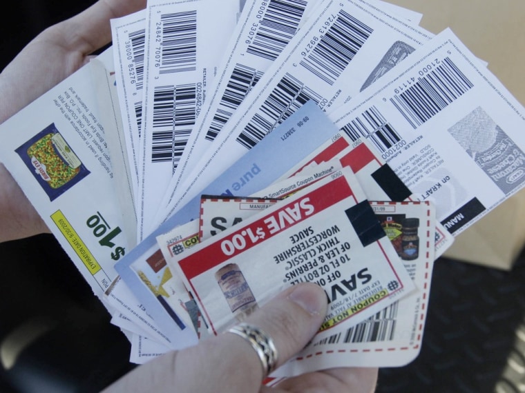 April Englebert shows a handful of coupons, including manufacturers' coupons she'd gotten by e-mail and ones she'd bought on eBay and printed out, outside a grocery store in Portland, Ore., in this July 14, 2009, photo.
