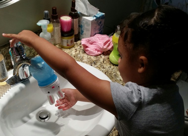 Daddy to the rescue: The much-loved Bunny sippy cup is repurposed to make hand washing more fun for 3-year-old Emiko.