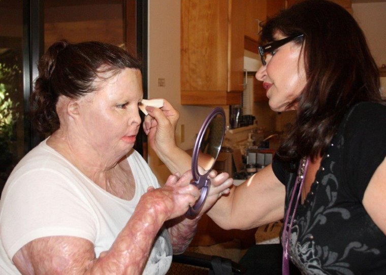 Nancy Ogden West, a corrective cosmetics professional, shows participant Stazia Porter how to apply makeup.