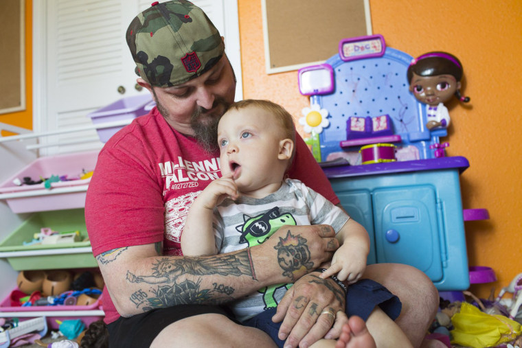 Image: Lance Stewart plays with his son Connor.