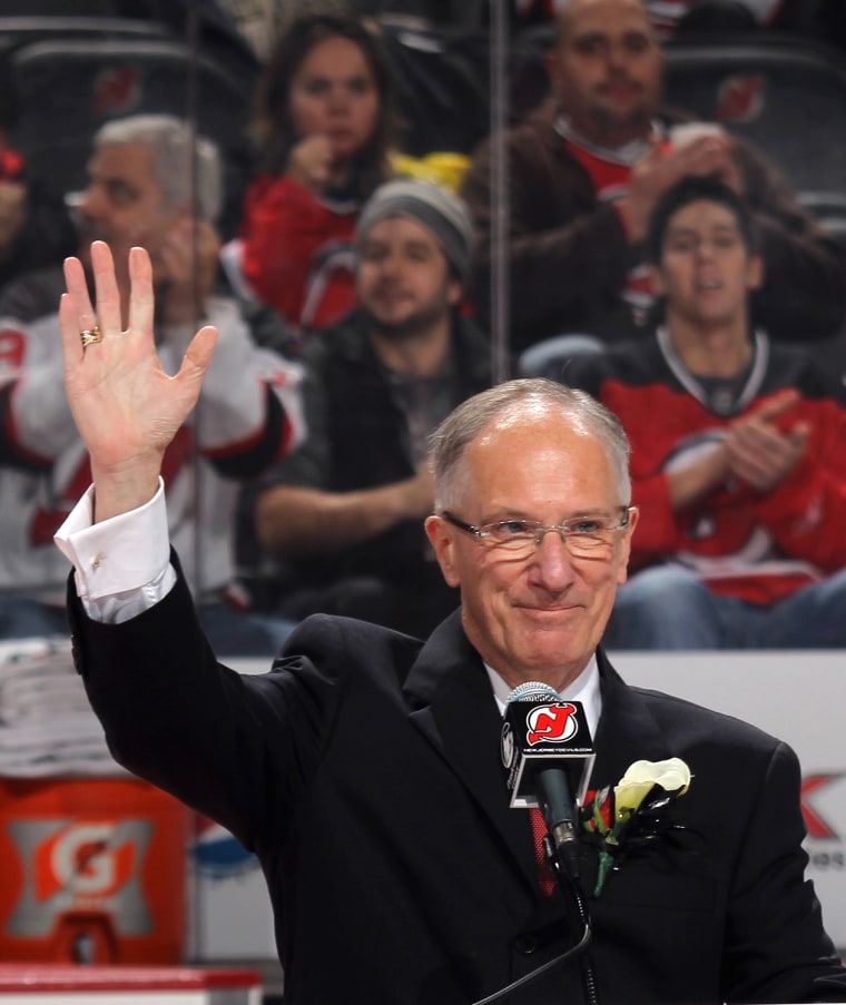 NEWARK, NJ - DECEMBER 16:  Mike \"Doc\" Emrick takes part in the Scott Niedermayer jersey retirement ceremony by the New Jersey Devils prior to the game...