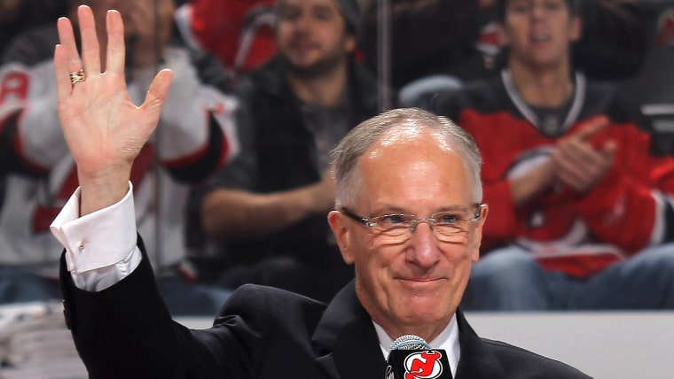 NEWARK, NJ - DECEMBER 16:  Mike "Doc" Emrick takes part in the Scott Niedermayer jersey retirement ceremony by the New Jersey Devils prior to the game...