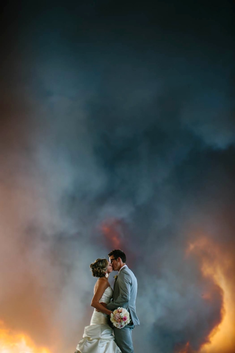 Photographer Josh Newton captured these images of April Hartley and Michael Wolber with a blazing wildfire as their backdrop.