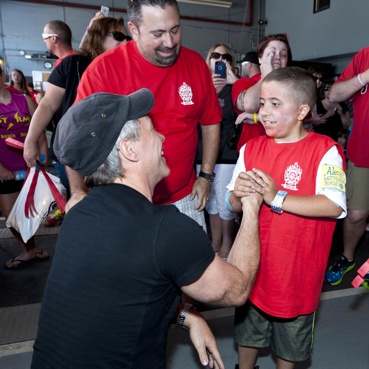 Mario Carpino meets Jon Bon Jovi, who made a surprise visit to Carpino's lemonade stand.