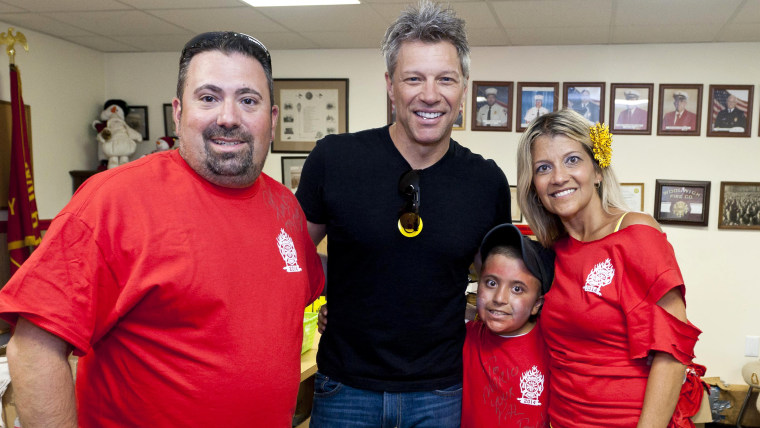 The Carpino family posing with Jon Bon Jovi for a photo.