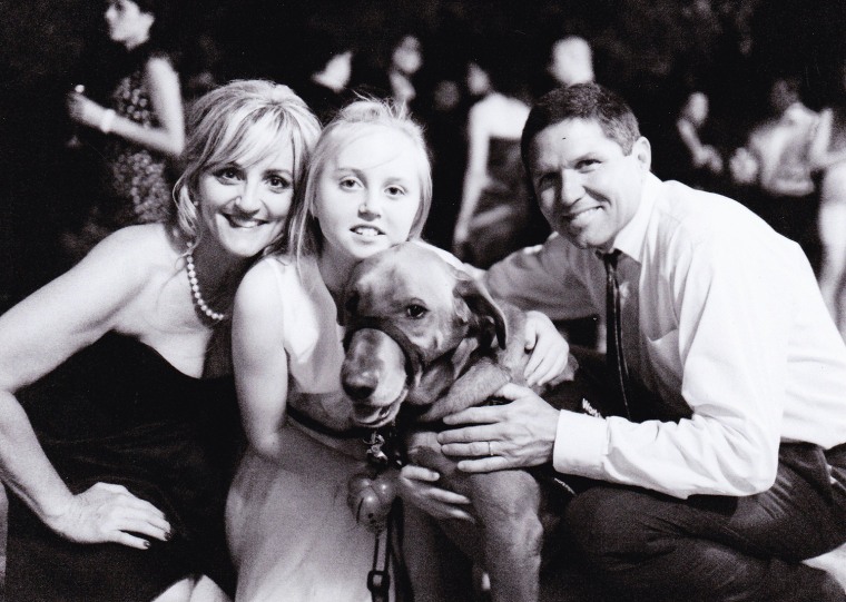 Rachel Benke and her family, including her guide dog Taxi, pose for a photo at a wedding.