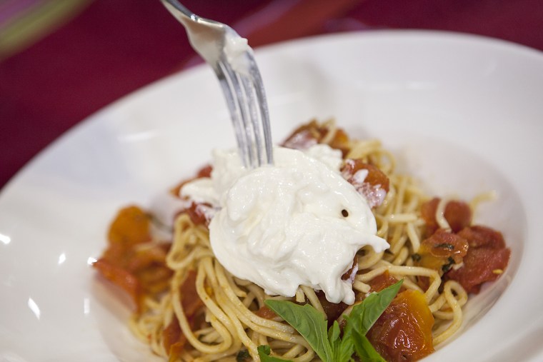 Spaghetti with spicy roasted tomatoes topped with stracciatella