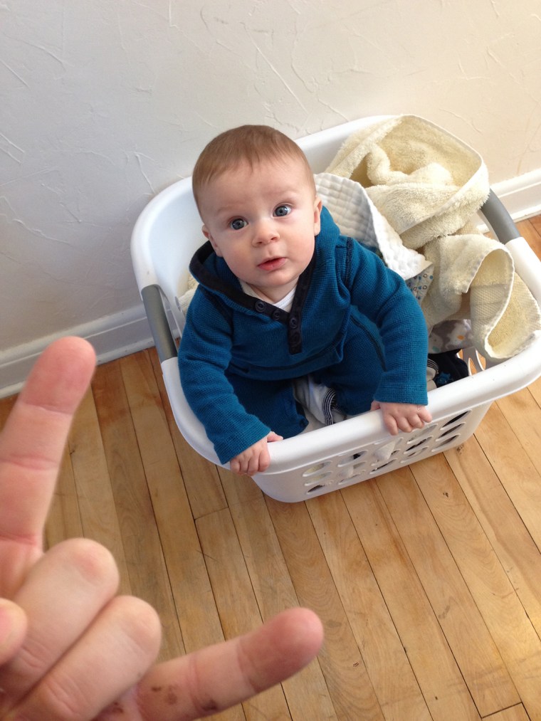 Brian Reda's son Livingston looks up at his dad from a laundry basket. Rock on!