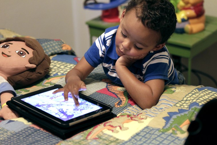 In this Friday, Oct. 21, 2011 photo, Frankie Thevenot, 3, plays with an iPad in his bedroom at his home in Metairie, La. About 40 percent of 2- to 4-y...