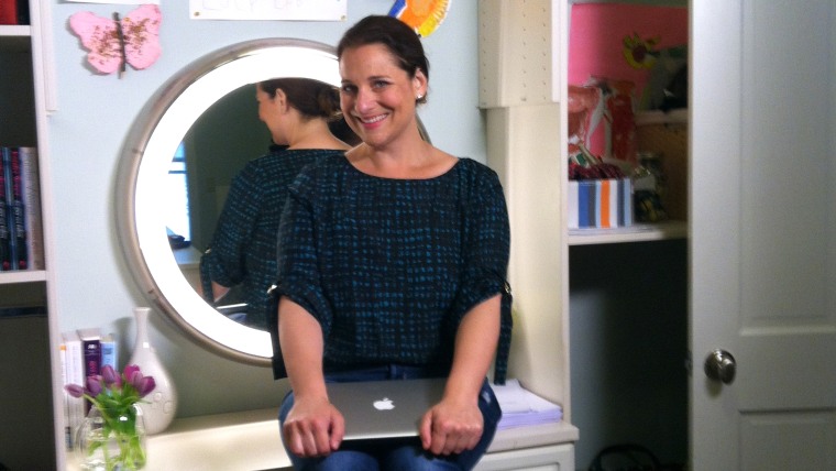 Jennifer Weiner poses at her desk, which sits smack dab in the middle of her closet.
