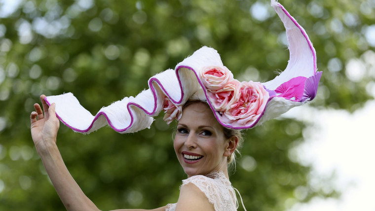 Anneka Tanaka-Svenska poses for photographers with a hat by milliner Louis Mariette on the first day of the Royal Ascot horse racing festival at Ascot...