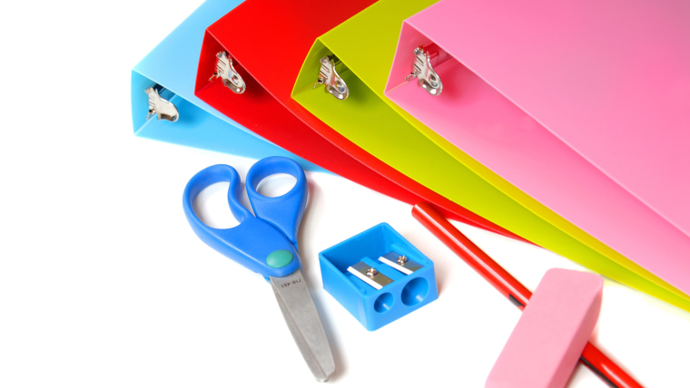 School supplies including binders, sissors, pencil, pencil sharpener and eraser
