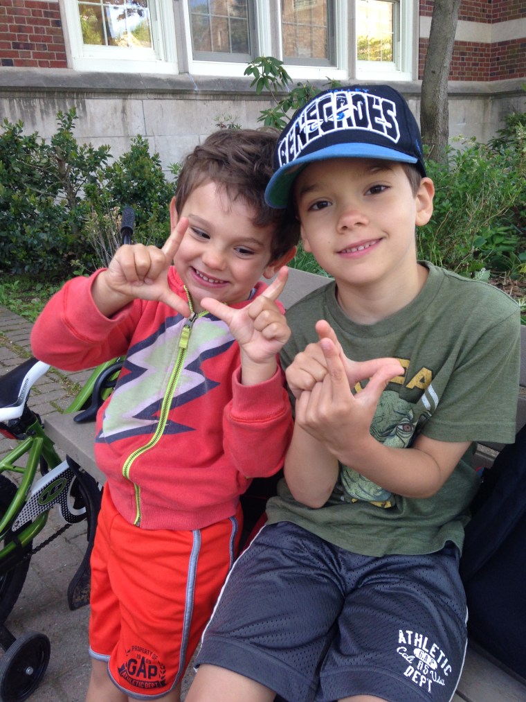 Erica's sons Weston (7) and Sawyer (4) flashing \"L\"s on the morning they walked / biked to school with their mother, for a total of 3 OutRUN miles (one from each of them).