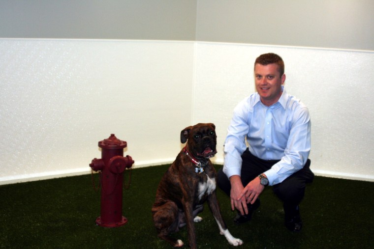A new \"dog lounge\" lets Spencer Norris bring his boxer, Benny, to his downtown Seattle office.