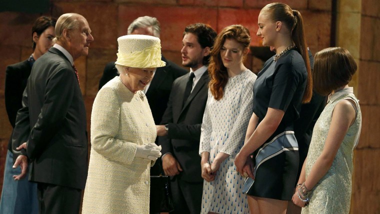 Britain's Queen Elizabeth and Prince Philip talk with members of the cast, including Sophie Turner (2nd R), on the set of the television show Game of ...