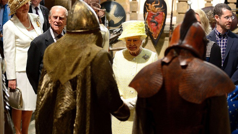 Britain's Queen Elizabeth II and Prince Philip, the Duke of Edinburgh views props and costumes during their visit to the set of the HBO TV series \"Gam...