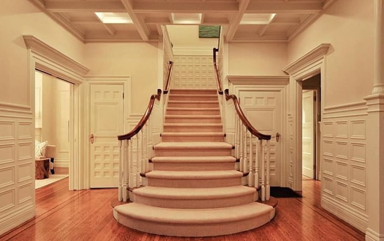 A grand staircase runs up the center of the home.