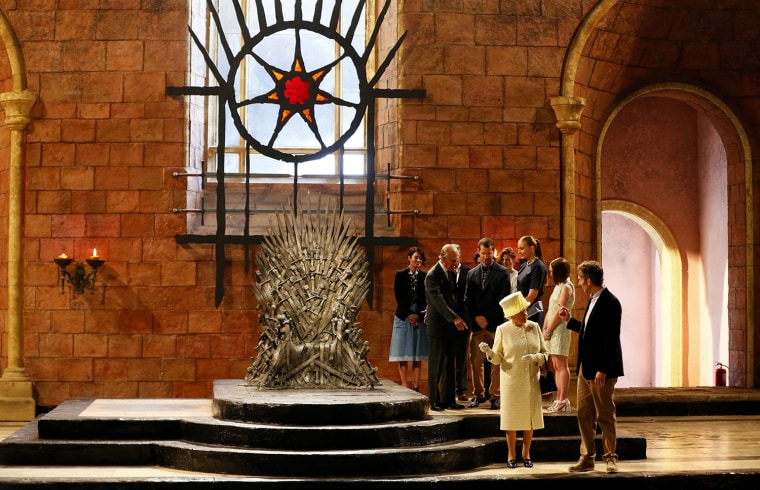 Britain's Queen Elizabeth and Prince Philip talk with members of the cast on the set of the television show Game of Thrones in the Titanic Quarter of ...