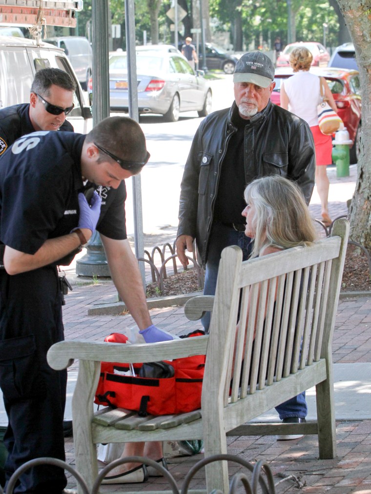 Image: Billy Joel comes to the aid of an unidentified woman.
