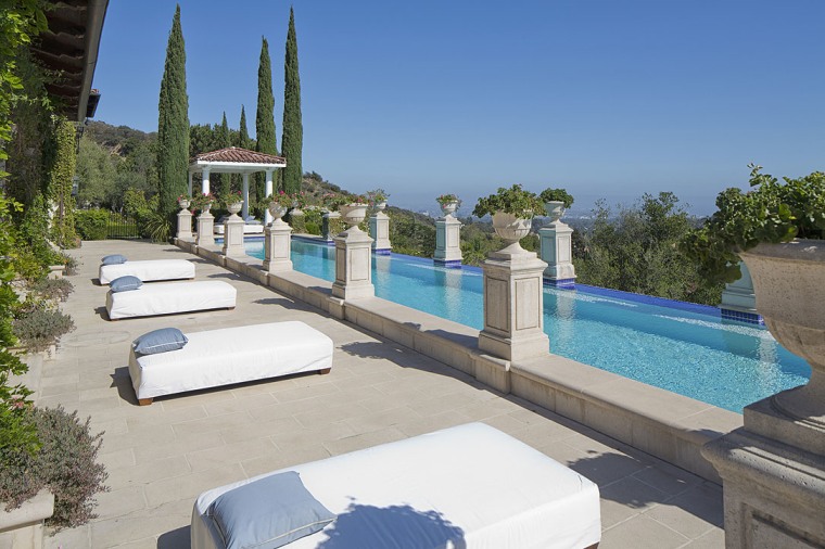 The property has multiple outdoor amenities, including this infinity-edge pool and spa.
