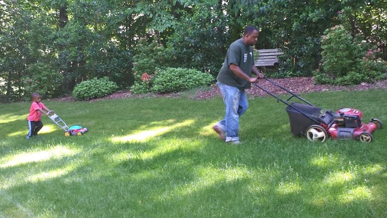 Chris Watkins and son Blake do some tandem mowing.