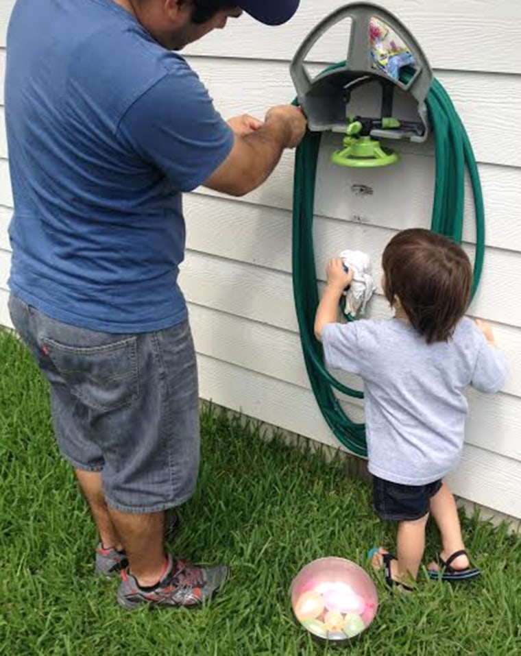 Josh Lara and son Elijah getting ready for a water balloon battle.