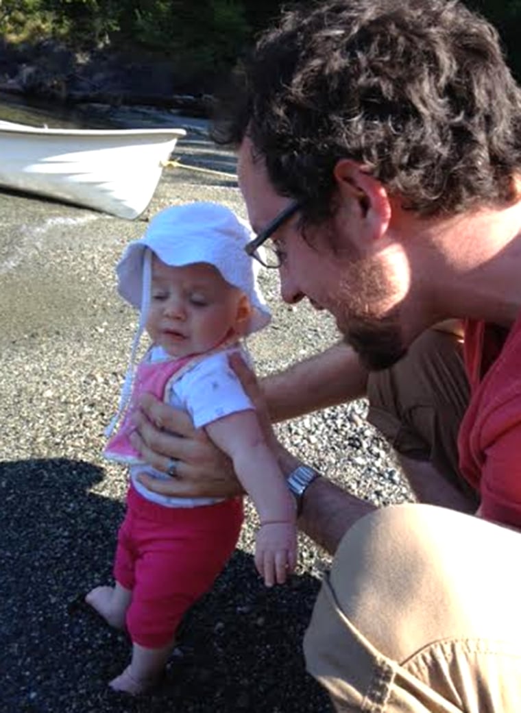 Todd Foley introduces his daughter's feet to sand for the first time.