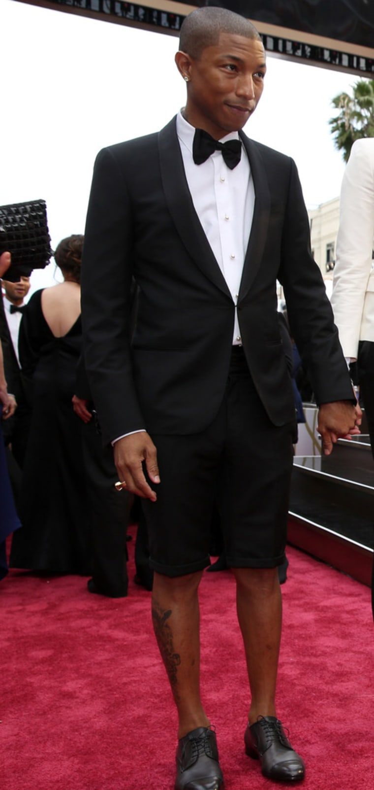 Pharrell Williams, left, and Helen Lasichanh arrive at the Oscars on Sunday, March 2, 2014, at the Dolby Theatre in Los Angeles.  (Photo by Matt Sayle...