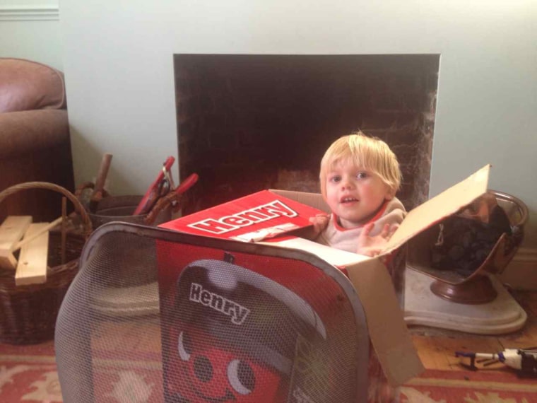 Hattie Garlick's son Johnny doesn't get new toys so he plays with found objects, such as this box (which is his rocket).