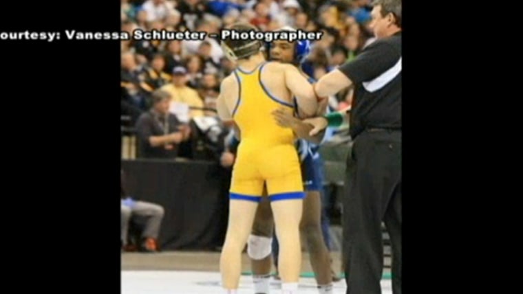 Malik Stewart (in blue) congratulated fellow sophomore Mitchell McKee after McKee pinned Stewart to win the 120-pound state title at the Minnesota wrestling championships. Stewart then went and gave a handshake and embrace to McKee's father.