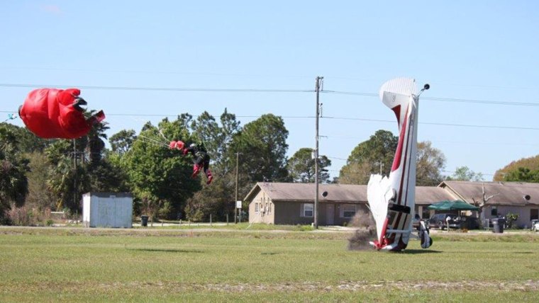 The plane nose-dives into the ground. Both the pilot and the skydiver survived.