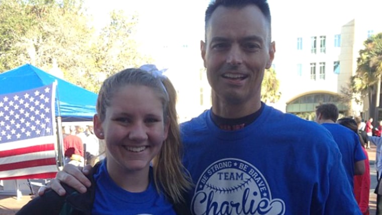 Teacher Charles Lundell, known as Charlie, with student Savannah Bendik at a cancer 5k race last year. Students wore team Charlie shirts and supported...