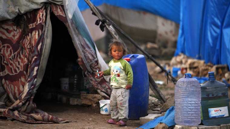 A Syrian refugee child stands outside a tent in the southeastern city of Kilis, near the Syrian-Turkish border, March 2, 2014. REUTERS/Nour Kelze (TUR...