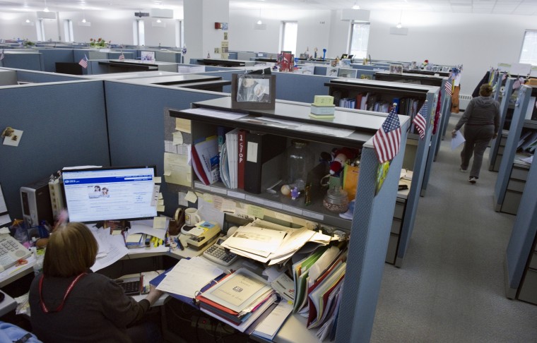 An employee works at her desk in Accounts Management at the IRS Andover Service Center in Andover, Mass. Employees field questions from the public, most often about tax laws or when they can expect to receive their refund.