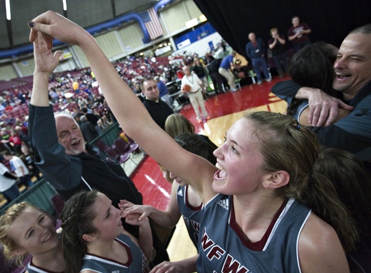 W.F. West's Julie Spencer high-fives coach Jack State after the team's girls' 2A basketball championship win over Mark Morris, 48-37, Saturday, March ...