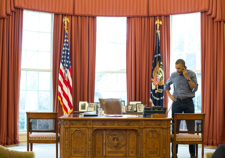 President Barack Obama talks on the phone in the Oval Office with Russian President Vladimir Putin about the situation in Ukraine, March 1, 2014.
(Off...