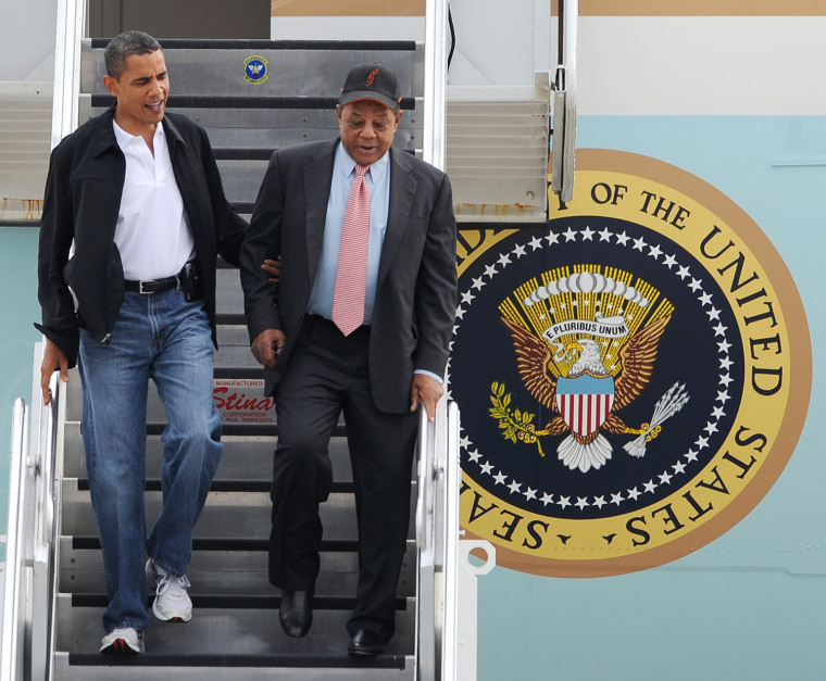 President Barack Obama, left, escorts Hall of Famer Willie Mays, right, on his arrival at Lambert St. Louis International airport Tuesday, July 14, 20...